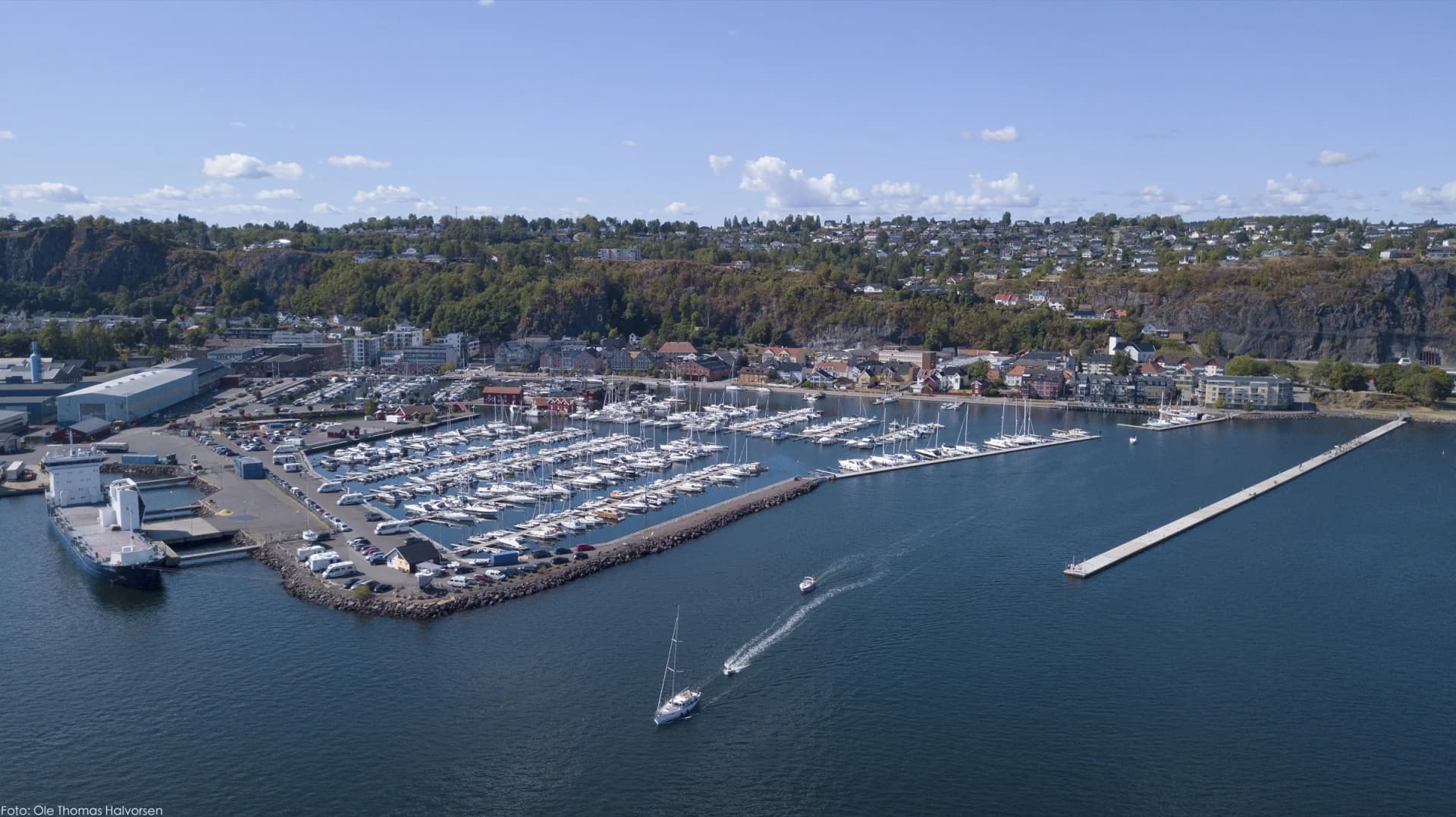 Holmestrand sett fra lufta — småbåthavna og byen under fjellveggen ved Oslofjorden