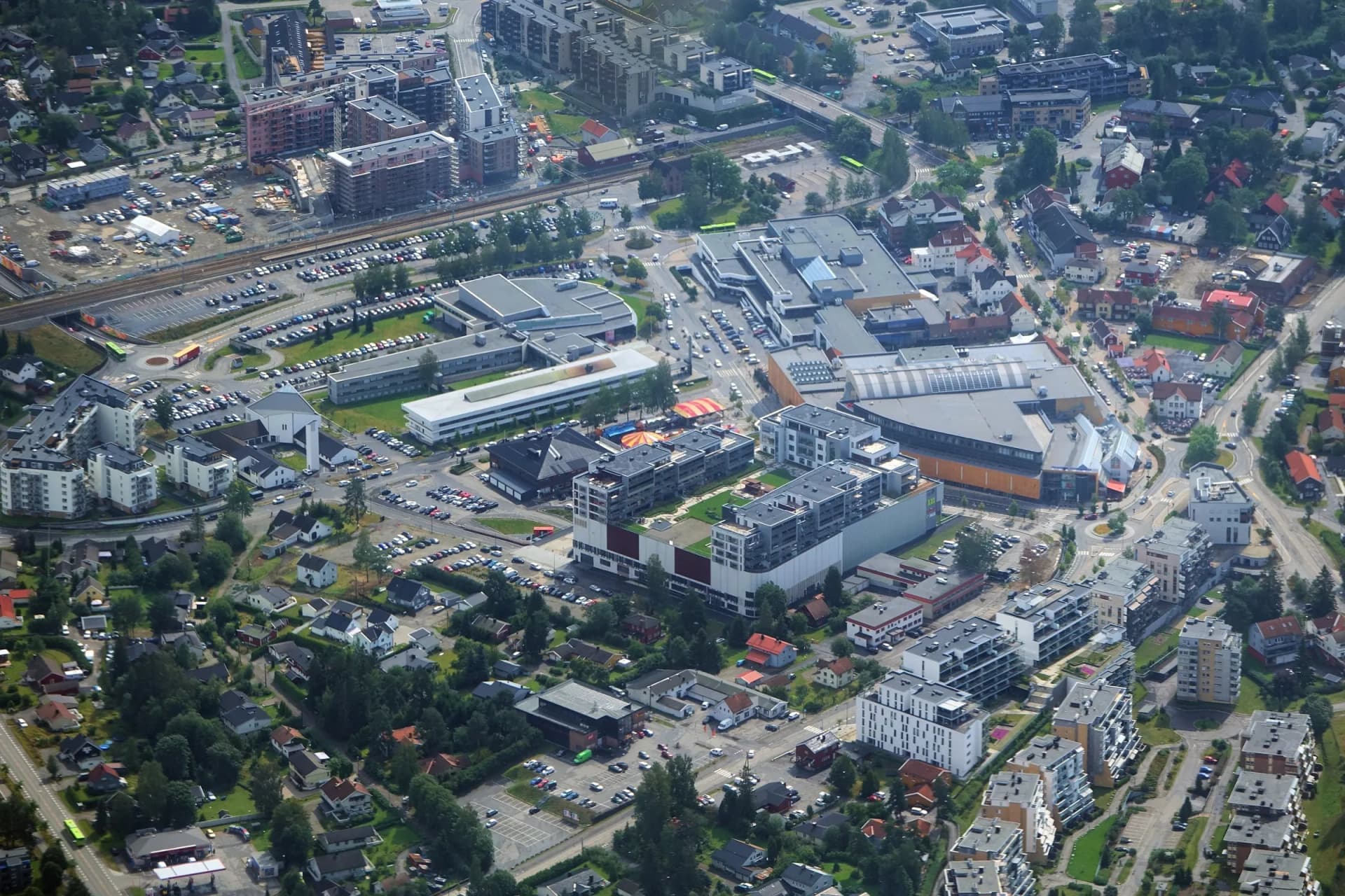 Jessheim sentrum i Ullensaker sett fra lufta, med jernbanestasjonen og storsenteret